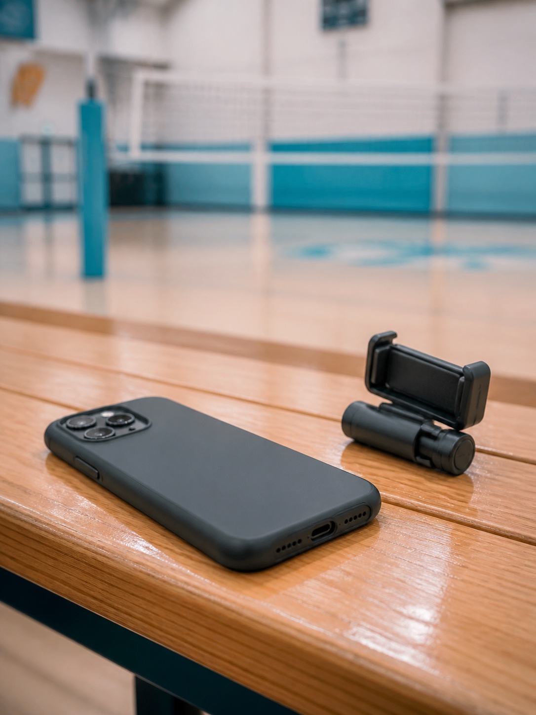 A phone and an optional pocket-size stand beside a volleyball court